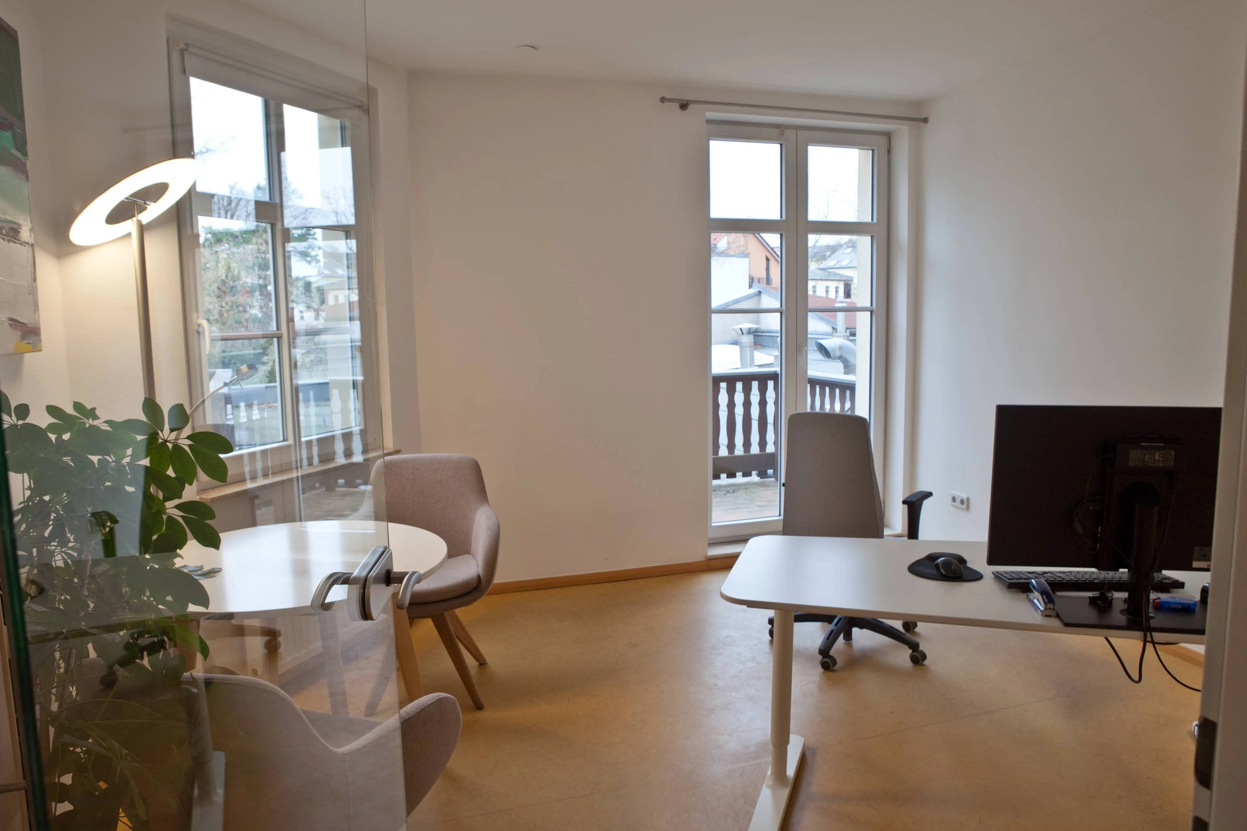Heller Büroraum mit Schreibtisch, Fenster und Pflanzen – Arbeitsplatz innen.